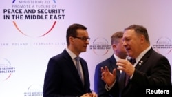Poland's Prime Minister Mateusz Morawiecki and U.S. Secretary of State Mike Pompeo talk during a Middle East summit in Warsaw, Poland, Feb. 14, 2019.