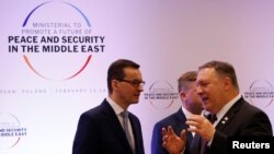 Poland's Prime Minister Mateusz Morawiecki and U.S. Secretary of State Mike Pompeo talk during a Middle East summit in Warsaw, Poland, Feb. 14, 2019. 