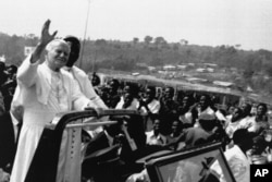 Pope John Paul II waves to the faithful before celebrating an open Mass in Kabgayi, 60 kms. southwest of Kigali, Rwanda, Sept. 8, 1990.
