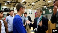 FILE - Candidate for Kansas governor Tyler Ruzich, second from right, 17, of Prairie Village, Kansas, talks to students during a forum at Free State High School in Lawrence, Kan., Oct. 19, 2017. 