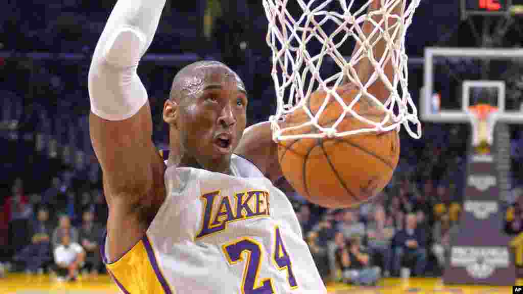 Los Angeles Lakers guard Kobe Bryant dunks during the first half of an NBA basketball game against the Indiana Pacers, Jan. 4, 2015, in Los Angeles, California.