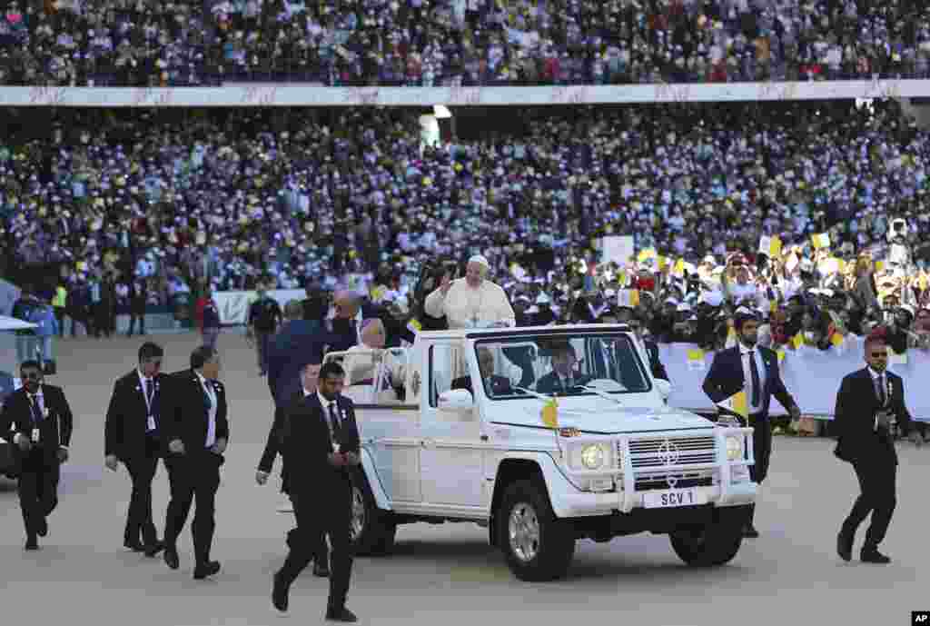 Pope Francis blesses worshippers during a Mass at the Sheikh Zayed Sports City in Abu Dhabi, United Arab Emirates.