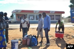 FILE - Street vendors prepare goods to sell in Macomia, northern Mozambique, June 11, 2018. A May 28 gunfight in the Cabo Delgado region between government soldiers and Islamist militants left at least 16 people dead and a dozen wounded.