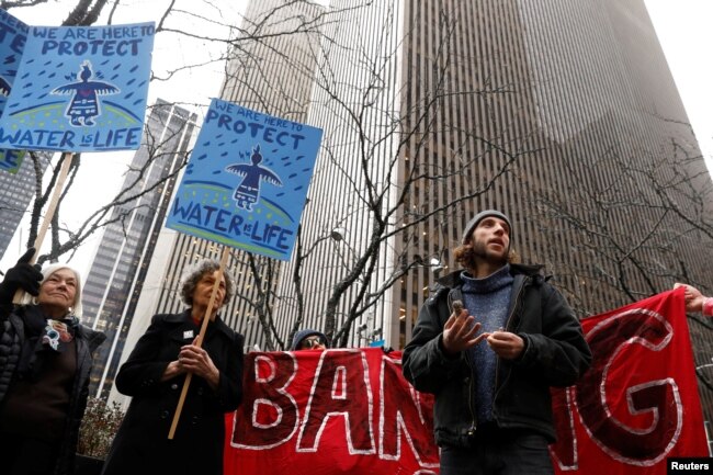 FILE - Demonstrators protest against the Dakota Access Pipeline, outside the Mizuho Bank in New York, Feb. 1, 2017.