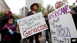 FILE - Diane Douglas Willard, right, demonstrates with her daughter, Gianna Willard, both Haida tribal members from Ketchikan, Alaska, during a Native American protest against Columbus Day.