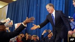 Doug Jones is greeted by a supporter before speaking during an election-night watch party, Dec. 12, 2017, in Birmingham, Ala. Jones defeated Republican Roy Moore, a one-time GOP pariah who was embraced by the Republican Party and the president even after facing allegations of sexual impropriety.