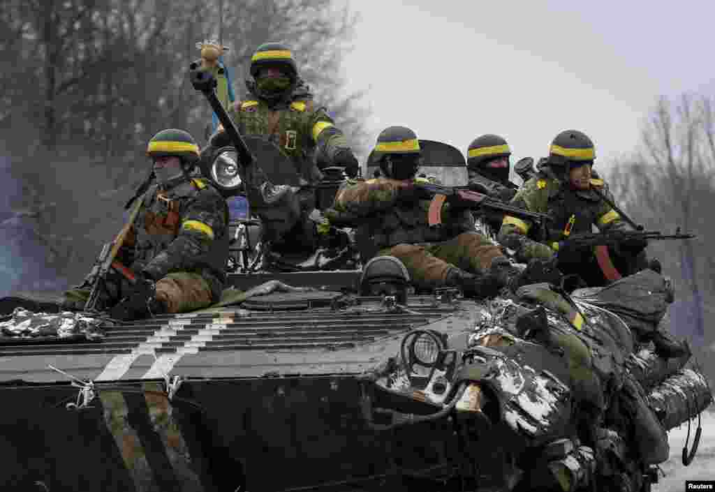 Members of the Ukrainian armed forces ride on an armored personnel carrier near Debaltseve, eastern Ukraine, Feb. 10, 2015.