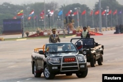 Commander-in-chief Min Aung Hlaing rides on a vehicle during a parade to mark Armed Forces Day in Myanmar's capital Naypyitaw, March 27, 2016.