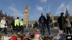 Des personnes viennent rendre hommage au Parlement à Londres, le 24 mars 2017.