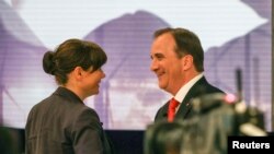 Opposition leader Asa Romson and leader of Sweden's Social Democrats Stefan Lofven shake hands at Sveriges Television (SVT), Sweden's national public TV station, in Stockholm, September 14, 2014.