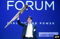 FILE - Ji Seong-ho, president of Now Action & Unity for Human Rights, holds up crutches at the Oslo Freedom Forum, May 26, 2015.