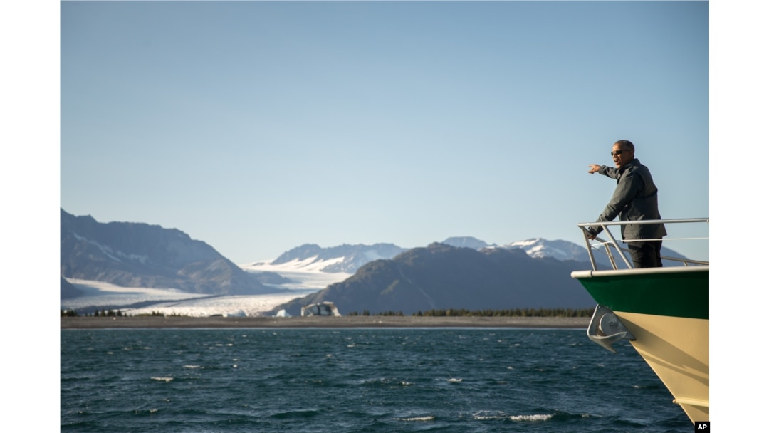 President Barack Obama looks at Bear Glacier, which has receded 1.8 miles in approximately 100 years, while on a boat tour to see the effects of global warming in Resurrection Cove, Tuesday, Sept. 1, 2015, in Seward, Alaska.