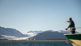 Former President Barack Obama looks at Bear Glacier while on a boat tour seeing the effects of climate change in Resurrection Cove, Tuesday, Sept. 1, 2015, in Seward, Alaska.