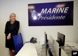 Trump effect and French elections: Far-right leader Marine le Pen poses as she inaugurates her campaign headquarters, Wednesday, Nov.16, 2016 in Paris. Le Pen is convinced that her anti-immigration, anti-Islam views can lead her to the presidency in five