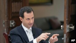 FILE - Syrian President Bashar Assad, photo by the Syrian official news agency SANA, in Damascus, May 10, 2018.