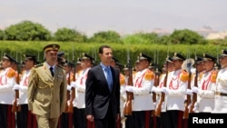 Syria's President Bashar al-Assad reviews a guard of honor before his swearing-in for a new seven-year term at the presidential palace in Damascus, July 16, 2014, in this picture released by Syria's national news agency SANA. 