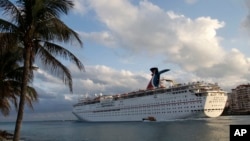 FILE - The Carnival Imagination cruise ship leaves the Port of Miami. Carnival cruise lines says it will allow Cuban-born passengers to book travel to Cuba.