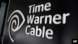 FILE - The Time Warner Cable corporate logo is displayed at a company store, in New York, May 26, 2015. U.S. lawmakers are skeptical about the entertainments giant's proposed merger with telecommunications powerhouse AT&T.