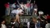 FILE - In this early June 1989, photo, civilians with rocks stand on a government armored vehicle near Chang'an Boulevard in Beijing as violence escalated between pro-democracy protesters and Chinese troops, leaving hundreds dead overnight.