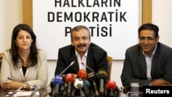 FILE - Pro-Kurdish politicians of Peoples' Democratic Party (HDP) Pervin Buldan (left) Sirri Sureyya Onder (center) and Idris Baluken attend a news conference in Ankara, Turkey, June 12, 2015. Buldan was detained briefly by Turkish police.