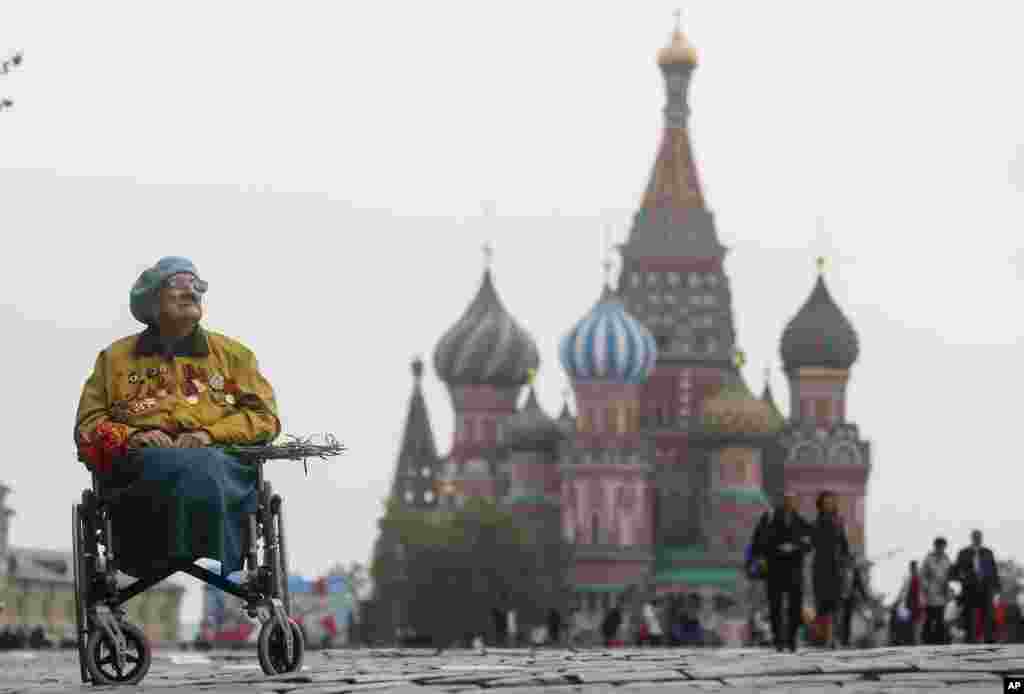 A veteran sits in a wheelchair in front of St. Basil&#39;s Cathedral after the Victory Day parade marking the 74th anniversary of the Allied victory over Nazi Germany in World War II, in Red Square in Moscow, Russia.