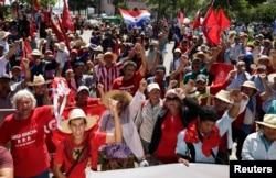 FILE - Paraguayan peasants march during a protest in the streets of downtown Asuncion, Feb. 10, 2015. The protesters marched to the front of the Congress building and presented their demands on land reform and other issues.