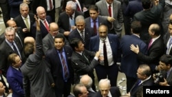 Deputies of the lower chamber of Brazil's Congress celebrate after they voted to reject a corruption charge against Brazilian President Michel Temer in Brasilia, Brazil, Aug. 2, 2017. 