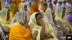 Mourners attend the funeral and memorial service for the six victims of the Sikh temple of Wisconsin mass shooting in Oak Creek, Wisconsin, Friday, Aug 10, 2012. 