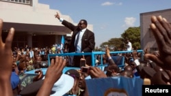 Malawi's President Peter Mutharika of the Democratic Progressive Party waves to supporters after he was sworn in in Blantyre, May 31, 2014.