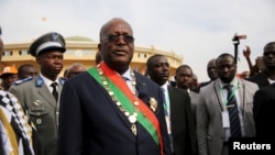 Burkina Faso President Roch Marc Kabore leaves his swearing in ceremony in Ouagadougou