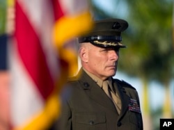 On Nov. 19, 2012, Gen. John F. Kelly stands at attention during the Southern Command change of command ceremony in Miami. He replaced Air Force Gen. Douglas Fraser, who retired from the military. Kelly was promoted to a four-star general.