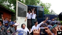 Student protesters, get off a police truck upon arrival at a township court for their trial Tuesday, July 14, 2015, in Tharyarwaddy township, Bago Division, north of Yangon, Myanmar. Student activists protested against a new education law at Letpadan in March 2015 appeared in a township court Tuesday for the 8th time of their trial in Tharyarwaddy. (AP Photo/Khin Maung Win)