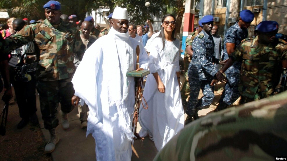 FILE - Gambian President Yahya Jammeh arrives at a polling station with his wife, Zineb, during the presidential election in Banjul, Gambia, Dec. 1, 2016.