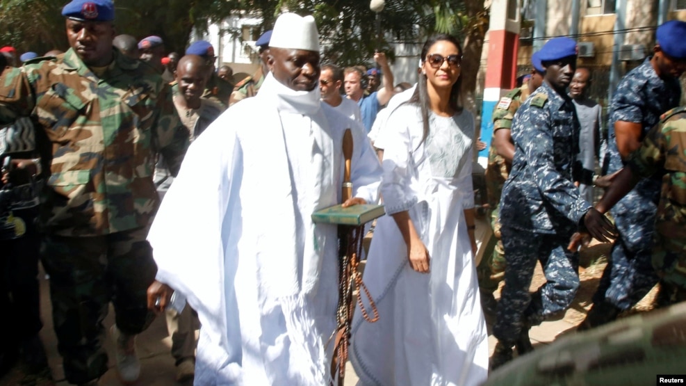 Gambian President Yahya Jammeh arrives at a polling station with his wife, Zineb, during the presidential election in Banjul, Gambia, Dec. 1, 2016.