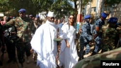 FILE - Gambian President Yahya Jammeh arrives at a polling station with his wife Zineb during the presidential election in Banjul, Gambia, Dec. 1, 2016. Jammeh is challenging the election results, in effect blocking the declared winner, opposition leader Adama Barrow, from assuming power.