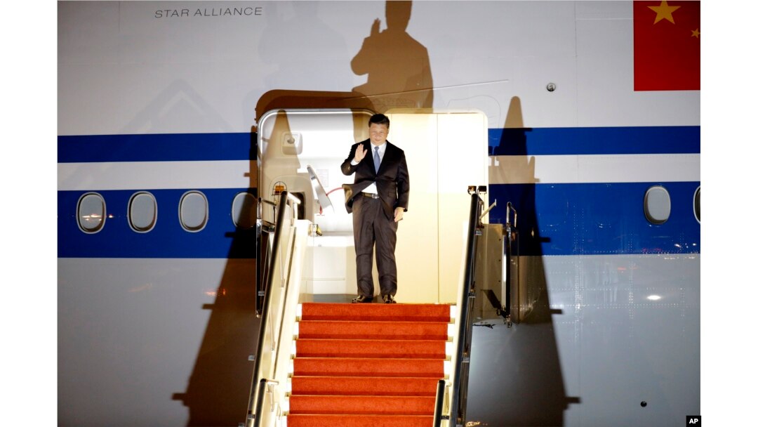 In this Nov. 15, 2018 photo, Chinese President Xi Jinping waves as he arrives at Port Moresby, Papua New Guinea.