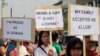 FILE - Indonesian gay activists hold posters during a protest demanding equality for LGBT people in Jakarta, Indonesia, May 21, 2011.