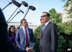 Treasury Secretary Steven Mnuchin speaks to members of the media at the White House in Washington, July 26, 2018.