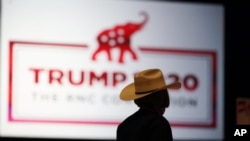 The room is set and delegates begin to arrive for the first day of the Republican National Convention, Monday, Aug. 24, 2020, in Charlotte, N.C. (AP Photo/Chris Carlson)