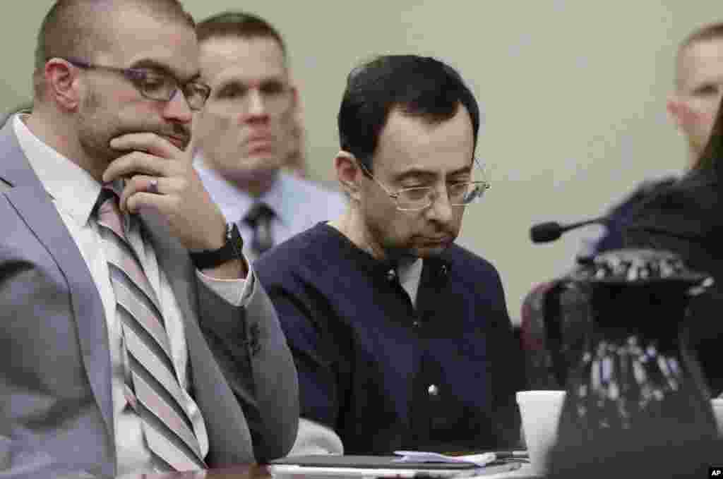 Larry Nassar sits with attorney Matt Newburg during his sentencing hearing in Lansing, Michigan. The former sports doctor who admitted molesting some of the nation&#39;s top gymnasts for years was sentenced 40 to 175 years in prison as the judge declared: &quot;I just signed your death warrant.&quot; The sentence capped a remarkable seven-day hearing in which scores of Nassar&#39;s victims were able to confront him face to face in the Michigan courtroom.