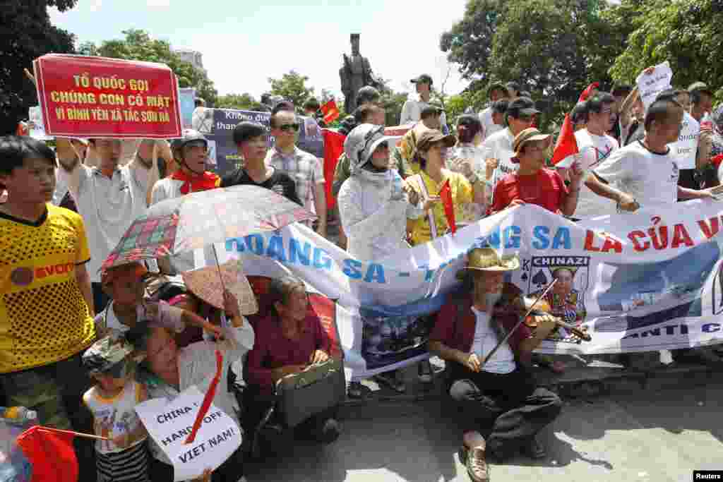 7月22日，越南人在河内一处公园举行反对中国的抗议。中国与越南和菲律宾在南中国海主权问题上激烈争吵，还发生船只对峙事件。(路透社照片)
