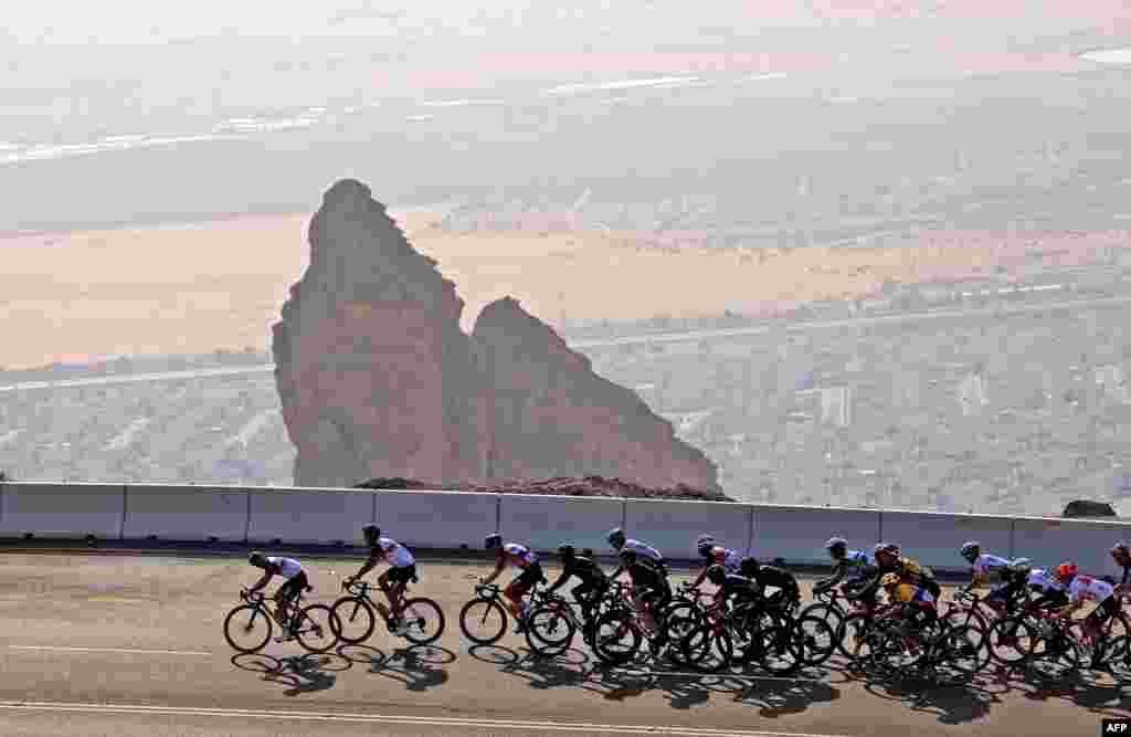 The pack rides during the third stage of the UAE Cycling Tour from Al Ain to Jebel Hafeet, United Arab Emirates.