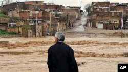A man watches as floodwaters hit the city of Khorramabad in the western province of Lorestan, Iran, April 1, 2019.