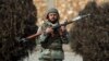 A national army soldier stands guard at the site of a clash between gunmen and security forces in Kabul, Afghanistan, Dec. 18, 2017. 