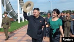 North Korean leader Kim Jong-Un and his wife Ri Sol-Ju attend the opening ceremony of the Rungna People's Pleasure Ground on Rungna Islet in Pyongyang in this July 25, 2012 photograph released by the North's KCNA.