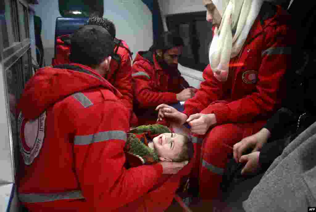Syrian staff from the International Committee of the Red Cross evacuate a baby in Douma in the eastern Ghouta region on the outskirts of the capital Damascus.
