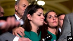 Families of US school gun shooting victims listen to news conference outside Senate chamber after a vote on gun legislation April 17, 2013