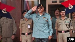 FILE - Then-Director General of Pakistani Rangers (Sindh) Karachi, Major General Rizwan Akhtar (C) salutes during a guard of honor prior to a meeting at India's Border Security Force (BSF) headquarters in New Delhi, July 2, 2012. 