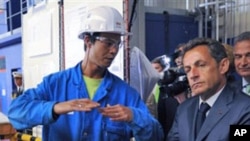 France's President Nicolas Sarkozy, right, listen to a worker during a visit at the Saint Nazaire naval plant, in Saint Nazaire, western France (File)