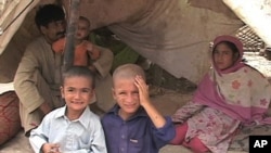 These Pakistani flood victims have set up camp near a busy roadway